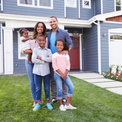 Happy,Black,Family,Standing,Outside,Their,House Happy black family standing outside their house